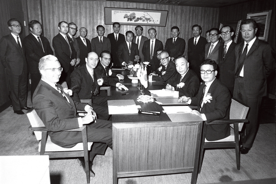 1970년 11월, 구자경 회장(테이블 앞줄 오른쪽)이 독일, 일본 등 3개국 4개 회사가 제휴한‘통신 전기기기 제조판매 수출사업을 위한 합작투자 기본계약'을 체결한 후 기념촬영을 하고 있다